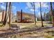 Expansive backyard featuring a deck, bench, and mature trees provides a serene outdoor living space at 1000 Weeping Willow Ln, Matthews, NC 28105