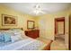 Bright bedroom featuring a ceiling fan, wooden dresser, and ensuite bathroom access at 1000 Weeping Willow Ln, Matthews, NC 28105