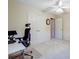 Bedroom featuring a ceiling fan, carpet, closet, and office desk setup at 1000 Weeping Willow Ln, Matthews, NC 28105