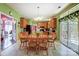 Bright dining area features a table with seating for six and slider access to a sunroom at 1000 Weeping Willow Ln, Matthews, NC 28105