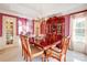 Formal dining room features a chandelier, china cabinet, and seating for six at 1000 Weeping Willow Ln, Matthews, NC 28105