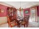 Formal dining room with chandelier, china cabinet, and elegant table setting at 1000 Weeping Willow Ln, Matthews, NC 28105