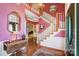 Bright foyer featuring a staircase, chandelier, hardwood floors, and a decorative front door at 1000 Weeping Willow Ln, Matthews, NC 28105