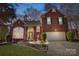 Charming brick home featuring a well-manicured lawn and an attached two-car garage at 1000 Weeping Willow Ln, Matthews, NC 28105