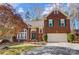 Lovely brick home featuring a two-car garage, landscaped front yard, and traditional architectural details at 1000 Weeping Willow Ln, Matthews, NC 28105