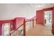 Hallway with carpet, wood railings, and a view into another bedroom at 1000 Weeping Willow Ln, Matthews, NC 28105