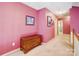 Upstairs hallway with light carpet, wooden chest and views into other rooms at 1000 Weeping Willow Ln, Matthews, NC 28105