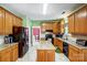 Traditional kitchen with granite countertops, wood cabinets, and stainless steel appliances at 1000 Weeping Willow Ln, Matthews, NC 28105