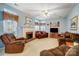 Cozy living room with a fireplace, comfortable seating, and plenty of natural light at 1000 Weeping Willow Ln, Matthews, NC 28105