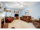 Comfortable living room featuring soft carpet, two sofas, an armchair, and a fireplace at 1000 Weeping Willow Ln, Matthews, NC 28105