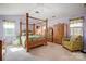 Spacious main bedroom with a four poster bed, ceiling fan, and natural light at 1000 Weeping Willow Ln, Matthews, NC 28105