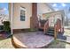 An elevated brick patio leads to an enclosed sunroom at the rear of this home at 1000 Weeping Willow Ln, Matthews, NC 28105