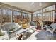 Relaxing sunroom with comfortable seating and sliding glass doors to access outdoors at 1000 Weeping Willow Ln, Matthews, NC 28105