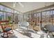 Bright sunroom with tiled floors, surrounded by windows, and views of wooded outdoors at 1000 Weeping Willow Ln, Matthews, NC 28105