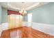 Formal dining room with hardwood floors and chandelier at 10318 Threatt Woods Dr, Charlotte, NC 28277