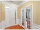 Bright entryway with hardwood floors and French doors at 10318 Threatt Woods Dr, Charlotte, NC 28277