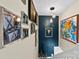 Gallery wall with eclectic mix of framed art and a statement light fixture at 11532 Delores Ferguson Ln # 1004, Charlotte, NC 28277