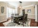 Formal dining room with hardwood floors, large table, and chandelier at 11925 Lawings Corner Dr, Huntersville, NC 28078