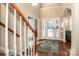 Two-story foyer with hardwood floors, a chandelier, and a staircase at 11925 Lawings Corner Dr, Huntersville, NC 28078