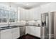 Modern kitchen with white cabinets, granite counters, and stainless steel appliances at 12 Tanglewood Rd, Clover, SC 29710