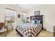 Spacious bedroom with a brown wooden bed frame and quilt at 13026 Serenity St, Huntersville, NC 28078