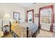 Charming bedroom with floral bedding and two windows at 13026 Serenity St, Huntersville, NC 28078