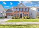 Brick two-story house with attached garage and landscaping at 13026 Serenity St, Huntersville, NC 28078