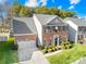 Two-story brick home with two-car garage and landscaped yard at 13026 Serenity St, Huntersville, NC 28078