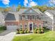 Two-story brick home with a two-car garage and landscaped yard at 13026 Serenity St, Huntersville, NC 28078