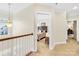 Upstairs hallway offering views of bedroom and office at 13026 Serenity St, Huntersville, NC 28078