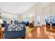 Open living room with hardwood floors, blue sofas and access to dining area at 13026 Serenity St, Huntersville, NC 28078