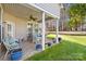 Relaxing patio with seating, potted plants, and a porch swing at 13026 Serenity St, Huntersville, NC 28078