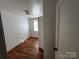 Simple bedroom with hardwood floors and a window at 1418 Winston Dr, Charlotte, NC 28205