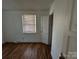 Simple bedroom featuring wood-look floors and ample natural light at 1418 Winston Dr, Charlotte, NC 28205