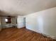 Bright living room featuring hardwood floors and built-in shelving at 1418 Winston Dr, Charlotte, NC 28205