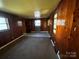 Spacious living room with wood walls and new flooring at 1418 Winston Dr, Charlotte, NC 28205