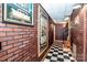 Checkerboard floor and brick accent wall in basement hallway at 148 Shawver Ln, Statesville, NC 28625