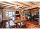 Spacious dining area in log cabin, showcasing wood features and fireplace view at 148 Shawver Ln, Statesville, NC 28625