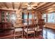 Rustic log cabin dining room with wood floors and a large wooden table at 148 Shawver Ln, Statesville, NC 28625