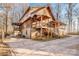 Rustic log cabin home with wrap-around porch and large driveway at 148 Shawver Ln, Statesville, NC 28625