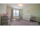 Bedroom with crib, dresser, and plenty of room for baby at 1585 Whitman Ct, York, SC 29745