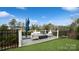 Relaxing deck with seating area and umbrella, offering scenic backyard views at 1585 Whitman Ct, York, SC 29745