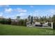 Elevated deck overlooking backyard, featuring seating and umbrella at 1585 Whitman Ct, York, SC 29745