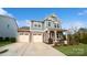 Two-story house with gray siding, stone accents, and a two-car garage at 1585 Whitman Ct, York, SC 29745