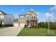 Two-story house with gray siding, stone accents, and a two-car garage at 1585 Whitman Ct, York, SC 29745