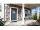 Inviting front porch with stonework, gray door, and two chairs at 1585 Whitman Ct, York, SC 29745