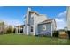 Rear view of two-story house showcasing gray siding and backyard landscape at 1585 Whitman Ct, York, SC 29745