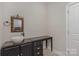 Bathroom with dark vanity, vessel sink, and ornate mirror at 1608 Traditions Ct, Waxhaw, NC 28173