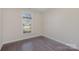 Simple bedroom with hardwood floors and large window at 1608 Traditions Ct, Waxhaw, NC 28173