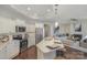 Open concept kitchen with island and living room view at 1608 Traditions Ct, Waxhaw, NC 28173